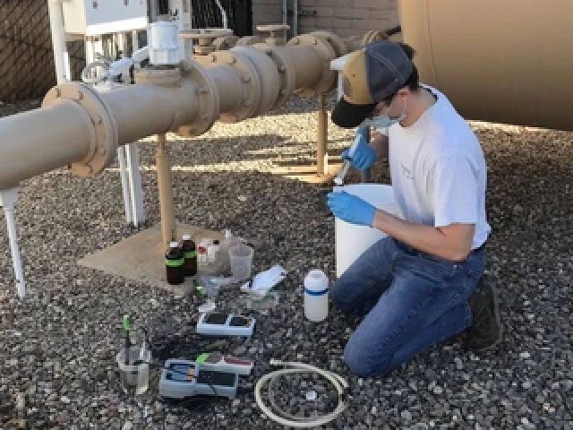 Chandler Noyes Collecting Well Water Sample Inline