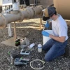 Chandler Noyes Collecting Well Water Sample Inline